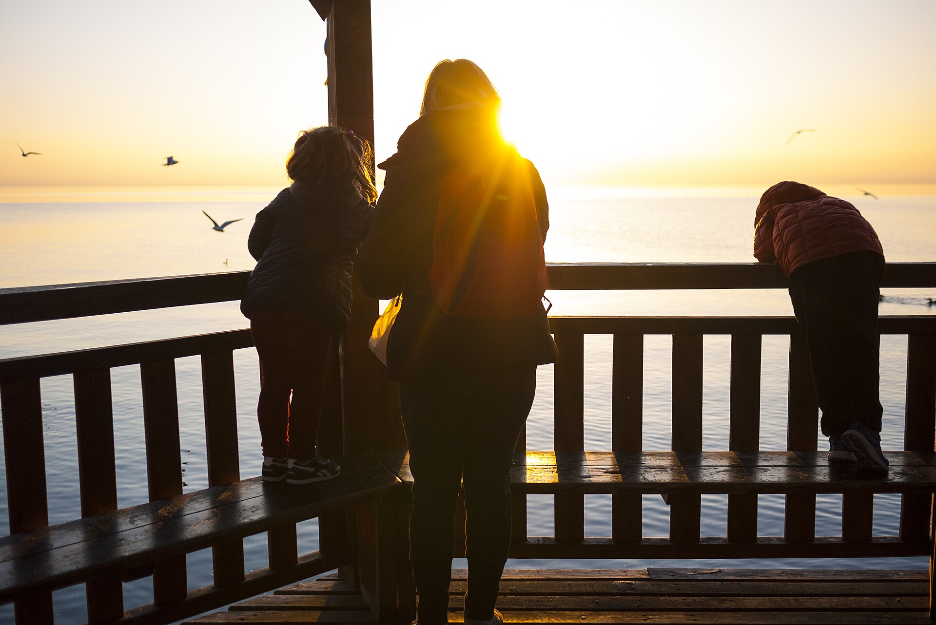 A parent and children together outdoors